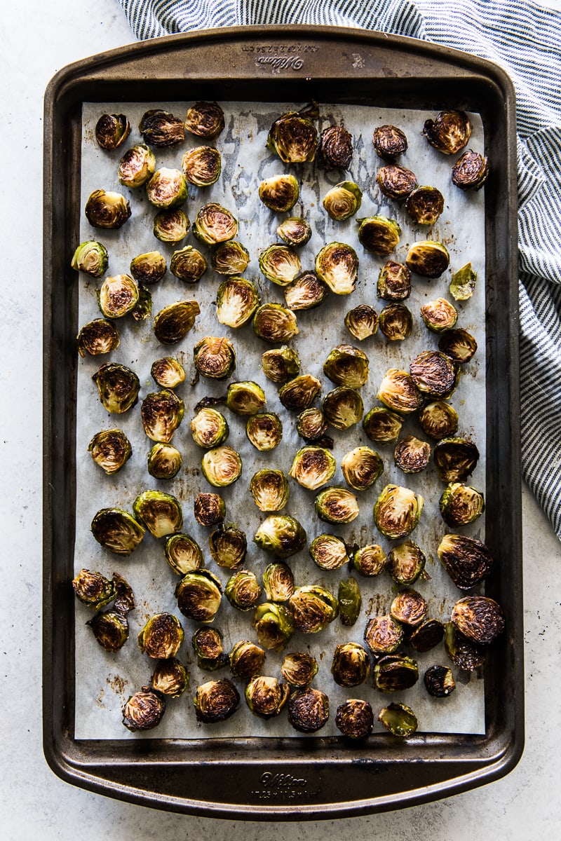 Roasted honey balsamic brussel sprouts on a baking sheet.