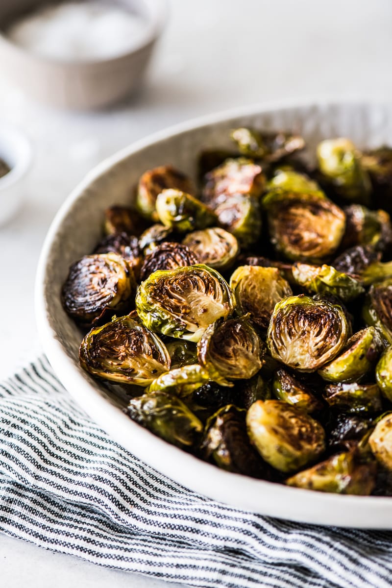 Honey balsamic brussel sprouts in a white bowl ready to be served.