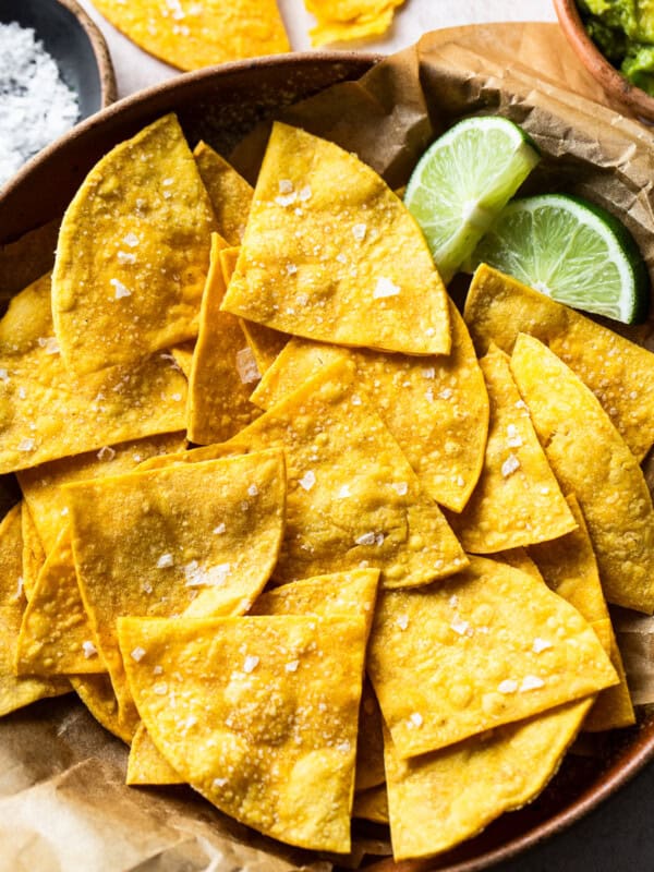 Baked tortilla chips in a bowl garnished with sea salt.