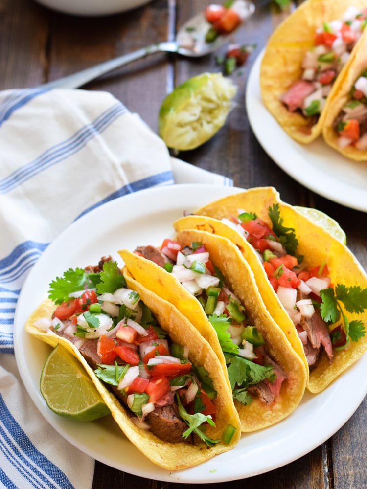 Topped with fresh pico de gallo salsa for an added crunch, these easy-to-make Marinated Flank Steak Tacos are juicy, bright and super flavorful. Perfect for any weeknight meal! (gluten free, dairy free, paleo)