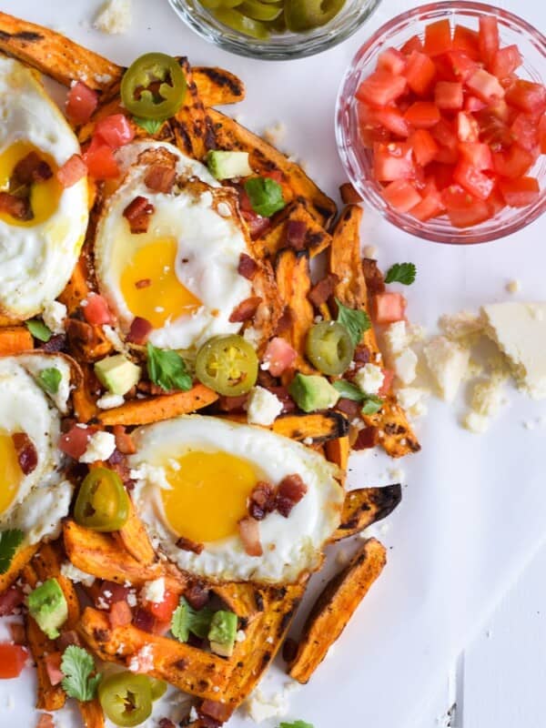 Baked Loaded Sweet Potato Breakfast Fries topped with sunny side up eggs, bacon, avocados and cotija cheese are sure to be your new favorite weekend breakfast.