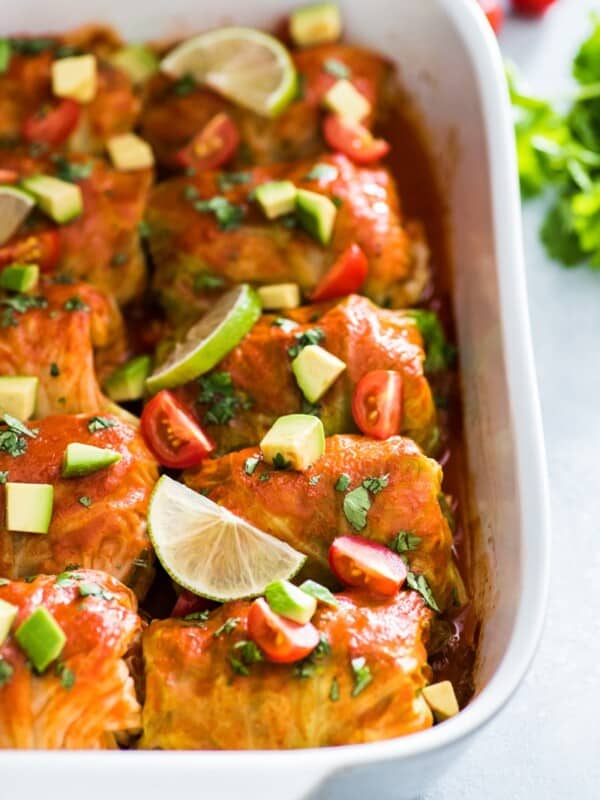 These Low Carb Enchilada Cabbage Rolls are made with cabbage leaves and stuffed with chicken, cheese and green chiles for a healthy weeknight meal!