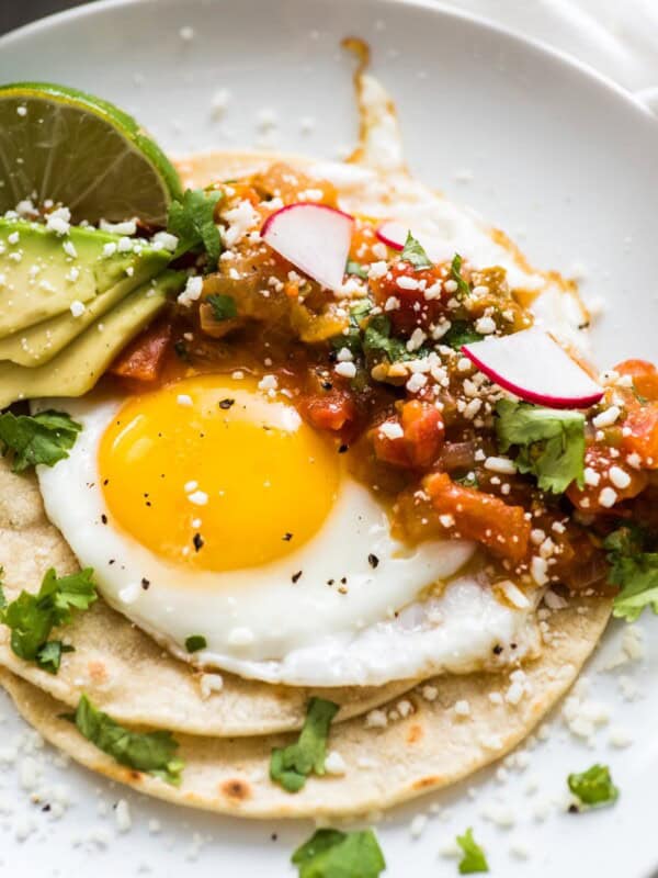 Huevos rancheros made from crispy corn tortillas, a fried egg, and salsa.