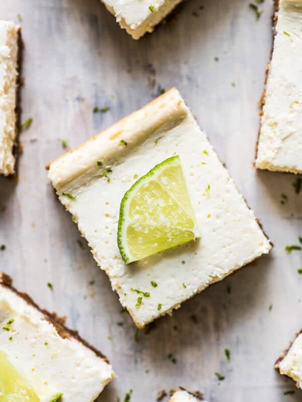 These Margarita Cheesecake Bars are creamy, made with a touch of tequila and sit on a buttery graham cracker crust.