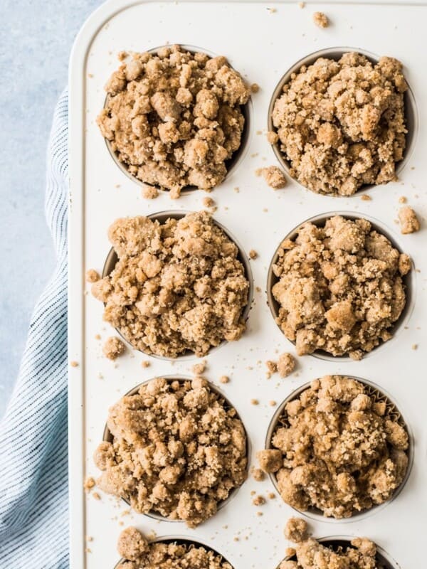 These cinnamon coffee cake muffins topped with a crunchy streusel topping are made with Greek yogurt for a healthier homemade treat!