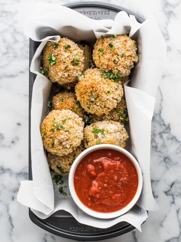 These arancini rice balls are Mexican-spiced savory rice balls filled with melted cheese and covered in crispy panko breadcrumbs baked to golden perfection.