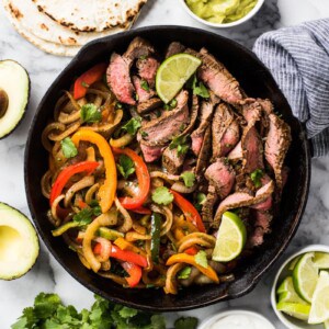 These Easy Steak Fajitas are juicy, tender, flavorful and way better than the ones at your favorite Mexican restaurant! Served with a healthy dose of peppers and onions, these fajitas are gluten free and low carb.