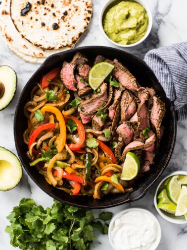 These Easy Steak Fajitas are juicy, tender, flavorful and way better than the ones at your favorite Mexican restaurant! Served with a healthy dose of peppers and onions, these fajitas are gluten free and low carb.