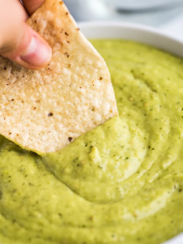 Guacamole salsa with a tortilla chip.