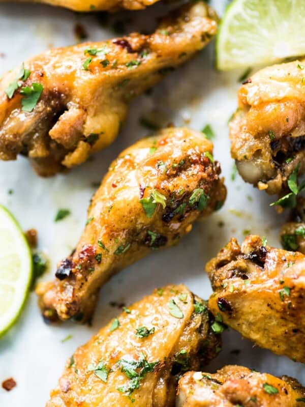 This baked chicken wings recipe creates flavorful crispy wings without using extra flours or coatings! Topped with a finger-licking good honey lime sauce, these wings are gluten free, low carb and paleo.