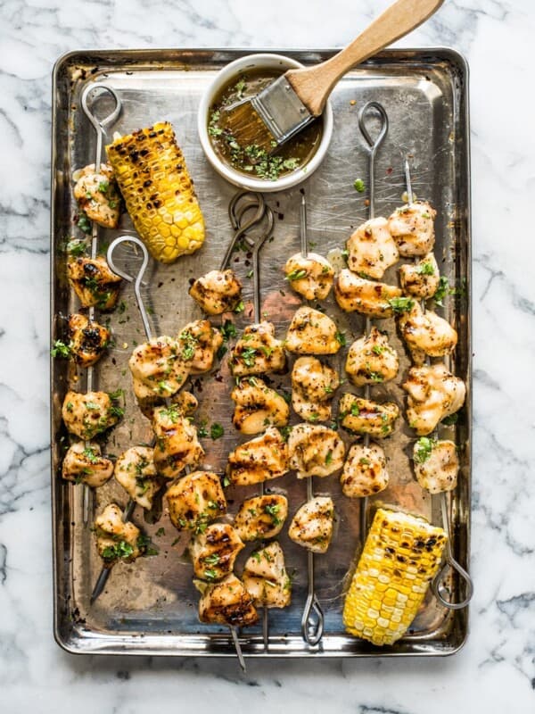 Grilled chicken kabobs on a baking sheet.