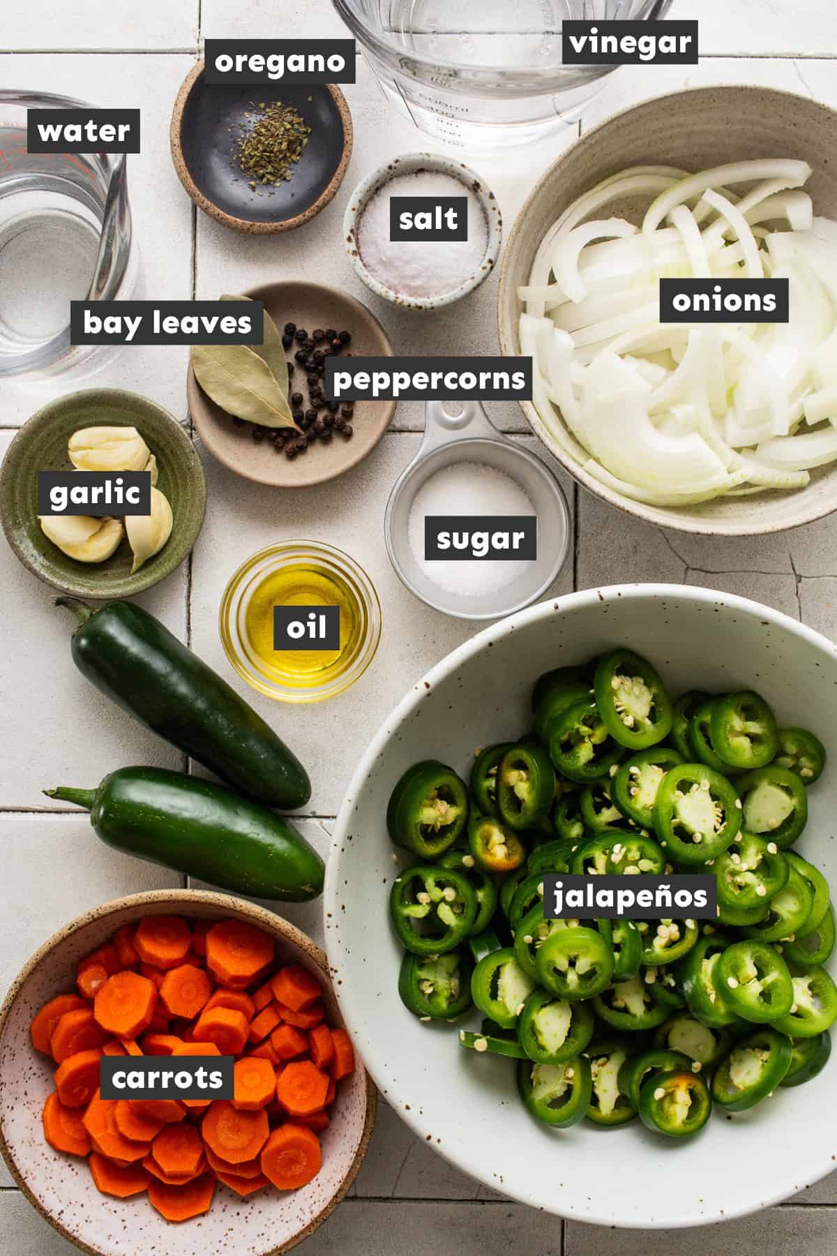 Ingredients for making pickled jalapeños on a table.