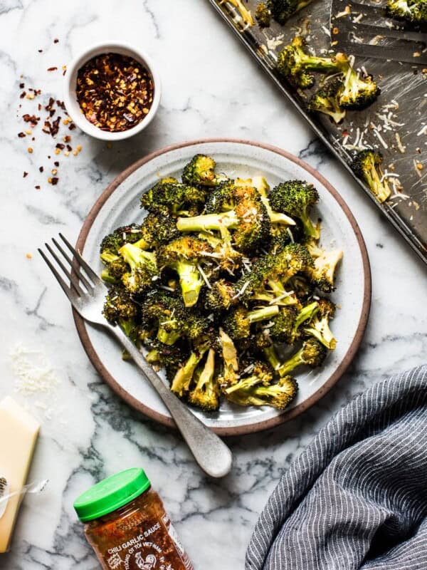 Ready in only 15 minutes, this Roasted Broccoli is tossed in a chili garlic sauce and topped with Parmesan cheese for a healthy and delicious veggie side dish!