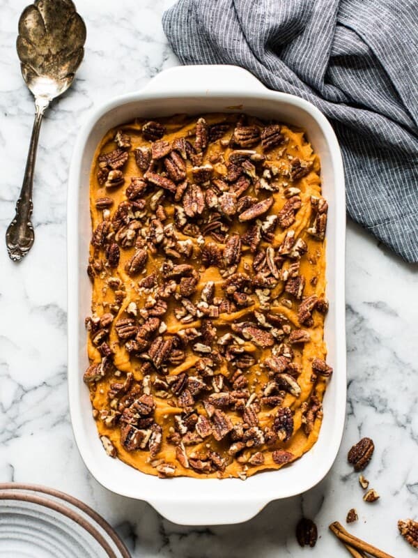 Healthy sweet potato casserole topped with candied pecans.