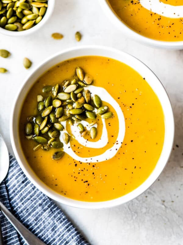 Roasted butternut squash soup in a white bowl.