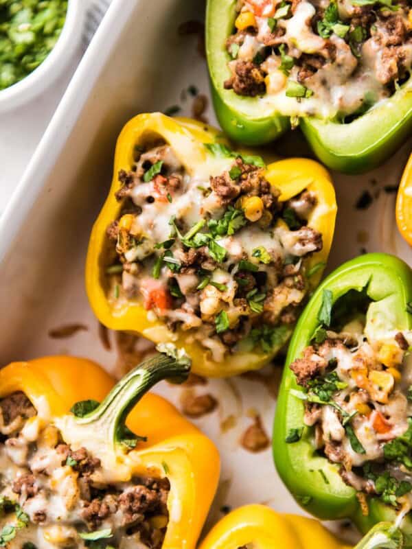 Mexican Stuffed Peppers filled with ground beef, chicken or turkey and seasoned with an easy taco seasoning perfect for weeknight meals!