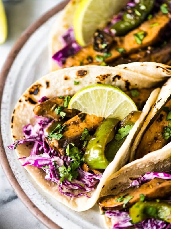 Mushroom tacos filled with marinated portabella mushrooms, bell peppers and red cabbage slaw