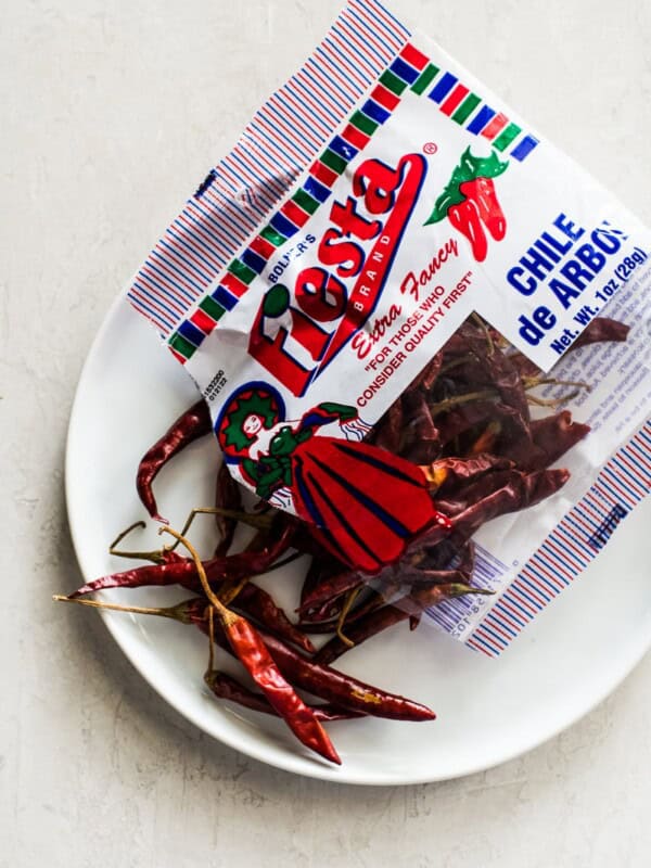 Chile de Arbol Peppers on a white plate.