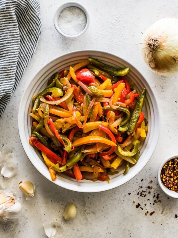 Sauteed Peppers and onions in a white bowl.