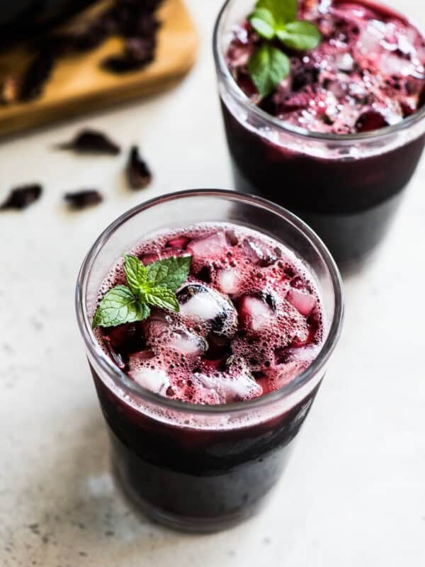 A glass filled with ice and Agua de Jamaica.