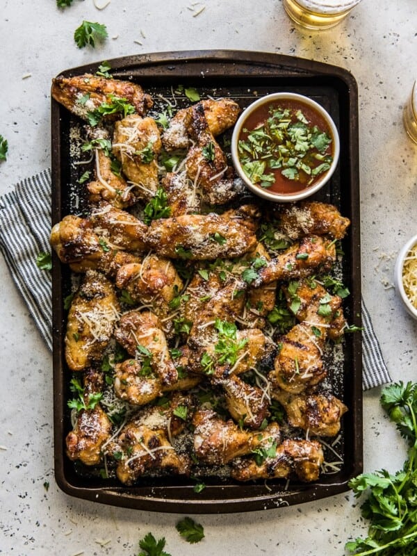 Grilled Garlic Parmesan Chicken Wings on a large serving platter topped with cilantro.