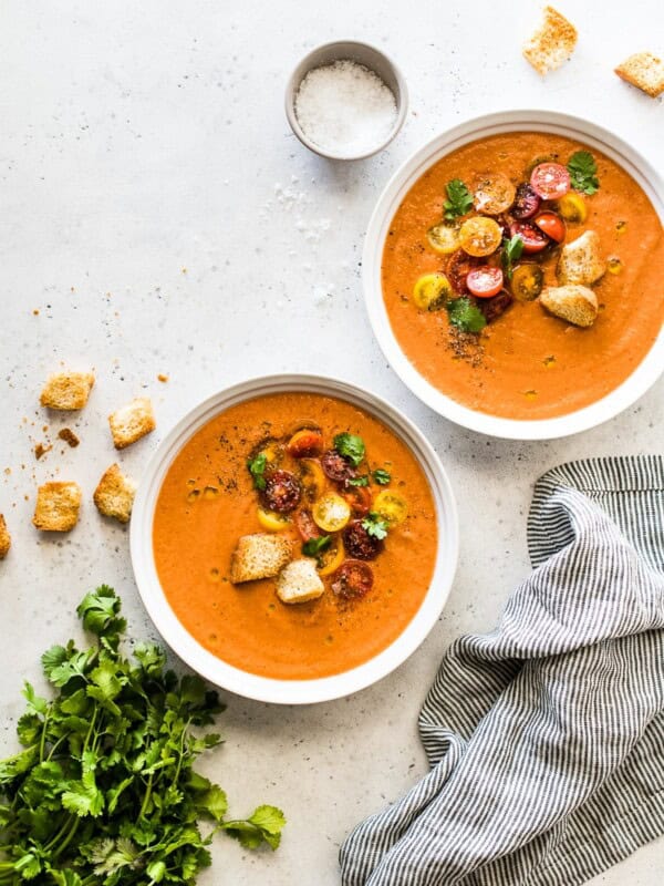 A refreshing and flavorful gazpacho recipe made from fresh sun-ripened tomatoes, cucumbers, bell peppers, onions and other simple ingredients. It's the best chilled soup you'll eat all summer! #gazpacho #summer #summerfood #soup