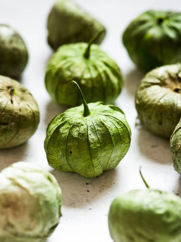 Tomatillos on a white table.