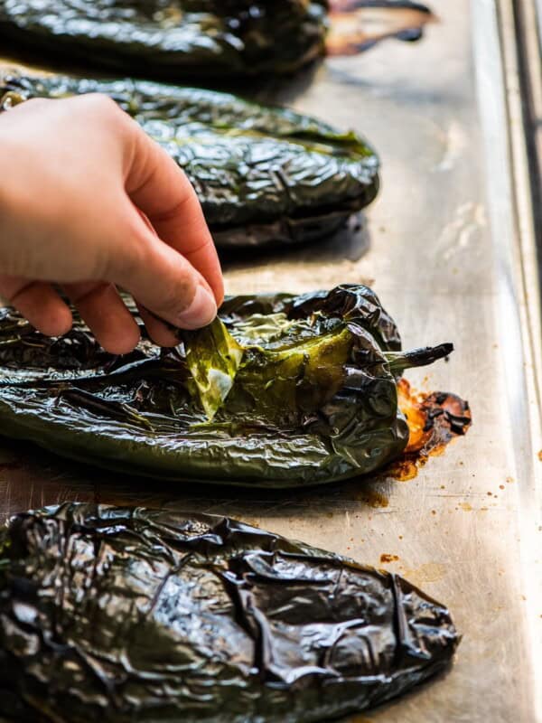 Pulling the skin off of roasted poblano peppers