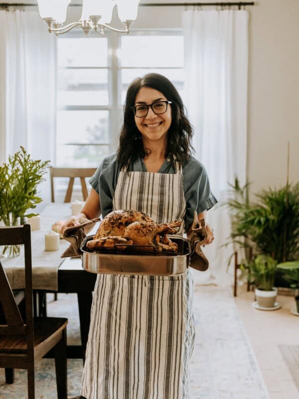 Isabel Orozco-Moore of Isabel Eats holding a turkey for Friendsgiving.