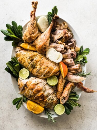 A carved turkey on a large white platter.