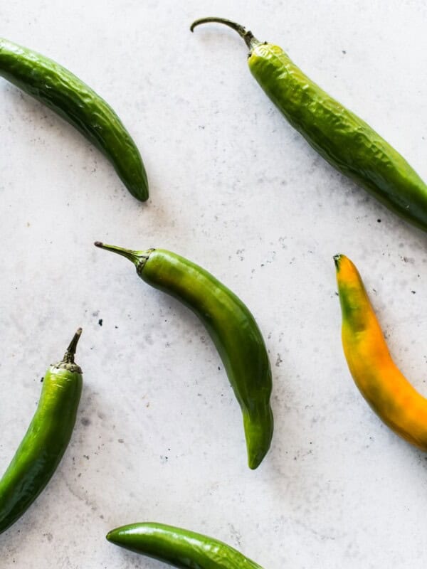 Serrano peppers on a white table.