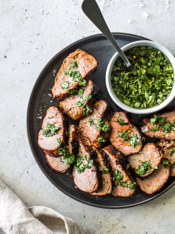 This Grilled Pork Tenderloin is an all-time grilling favorite! Rubbed with a blend of smoky spices like chipotle powder, ground cumin and smoked paprika, this recipe makes unbelievably juicy pork every single time. #porkrecipes #grillingrecipes #porktenderloin