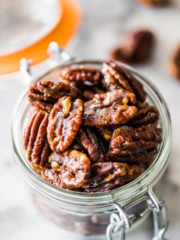 These candied pecans are easy to make on the stovetop - no need to turn on the oven! Crunchy, sweet and the perfect little snack, they're ready in under 10 minutes. Perfect for topping on salads and dessert, they even make a great holiday gift! #candiedpecans #holidays #pecans