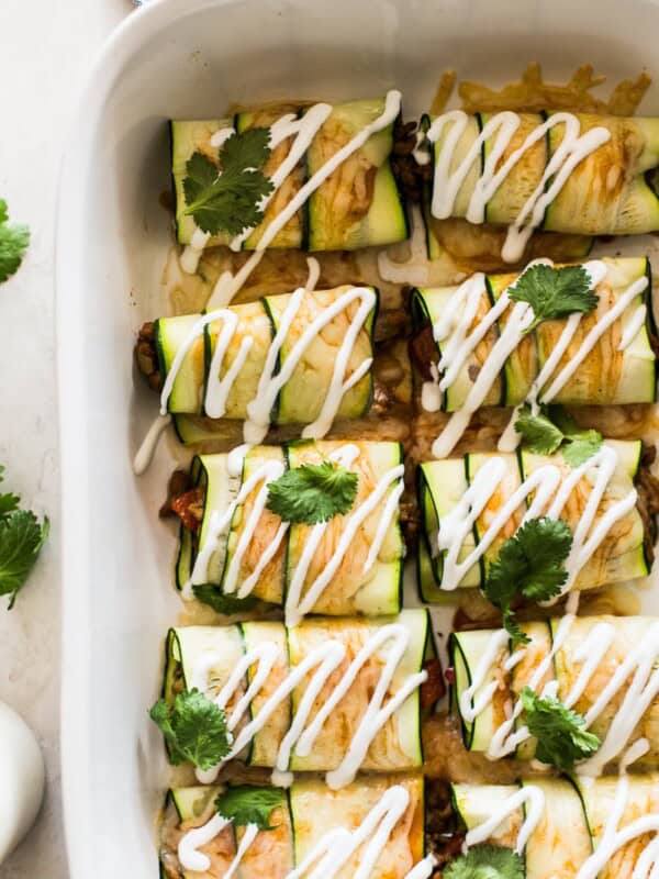 Zucchini Enchiladas topped with sour cream and cilantro