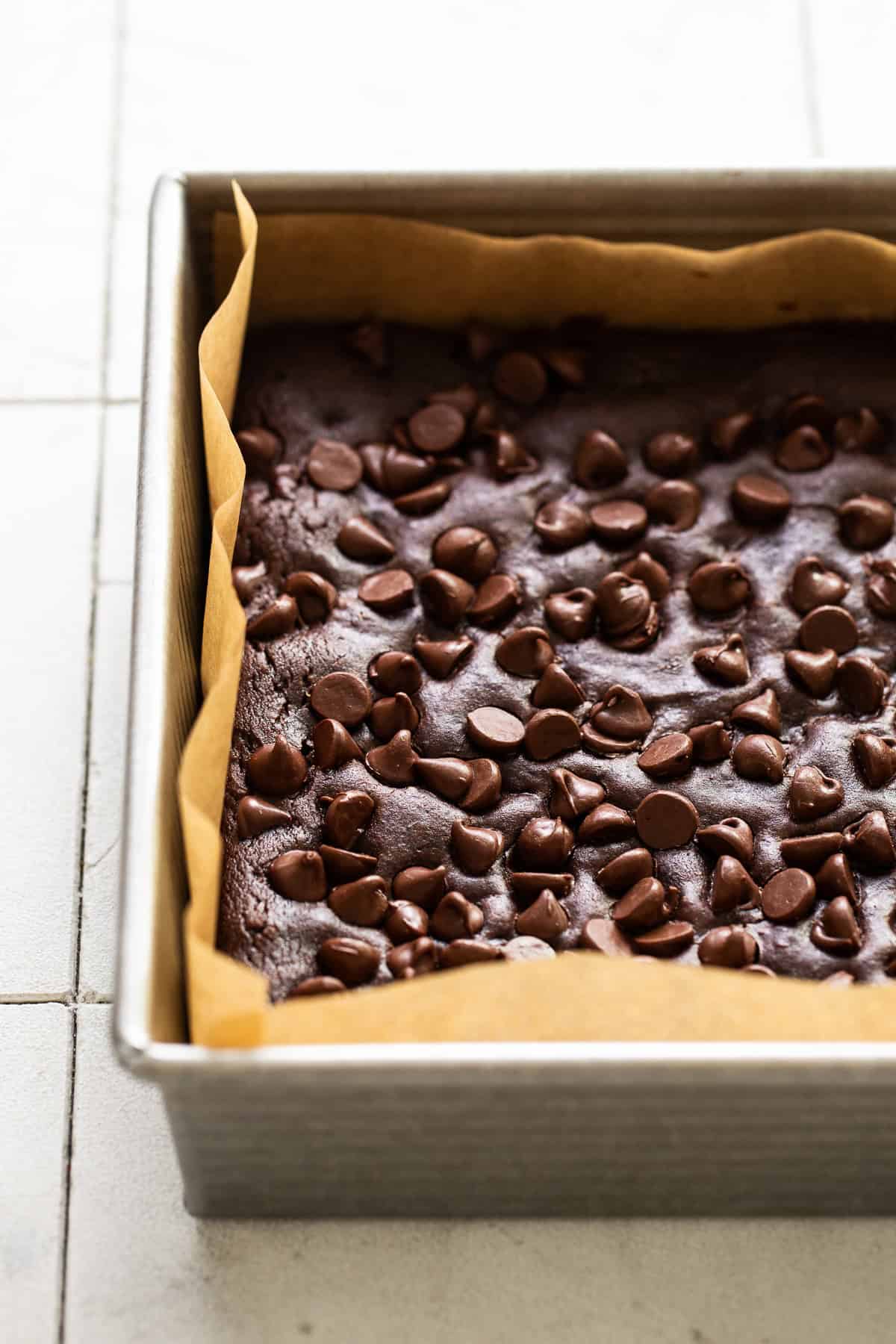 Baked black bean brownies in a pan before being cut and served.