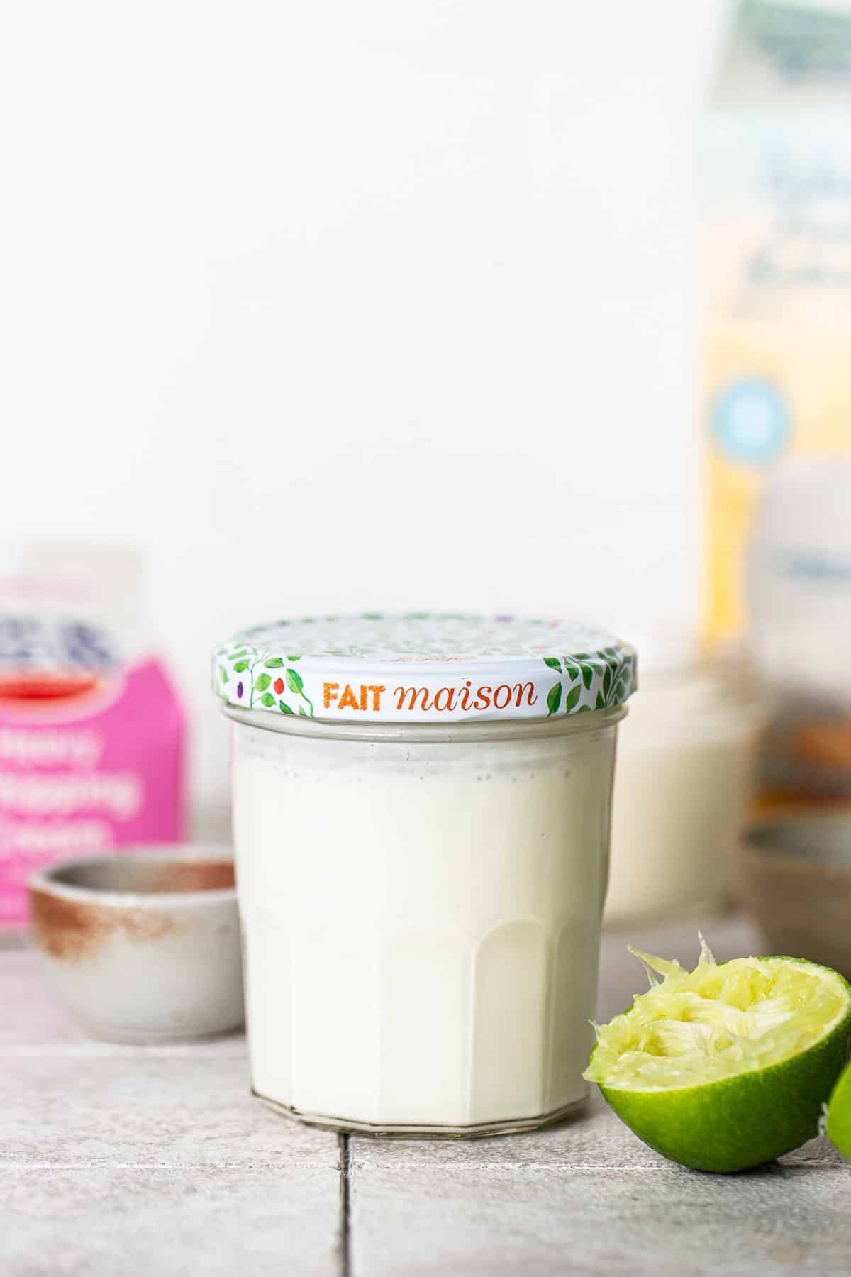 Mexican crema in a jar with a lid ready to be fermented.