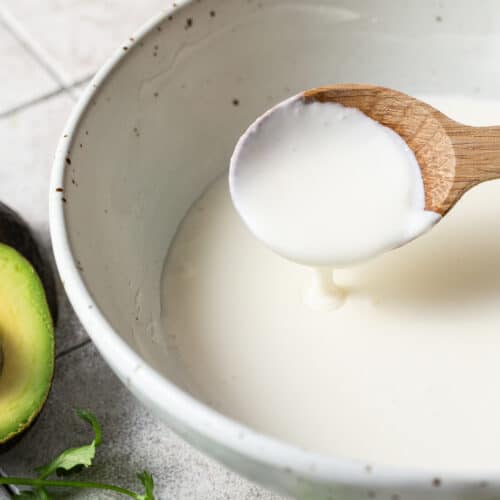 Mexican crema in a bowl with a spoon.