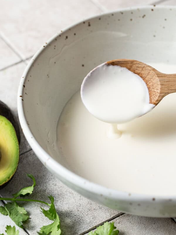 Mexican crema in a bowl with a spoon.