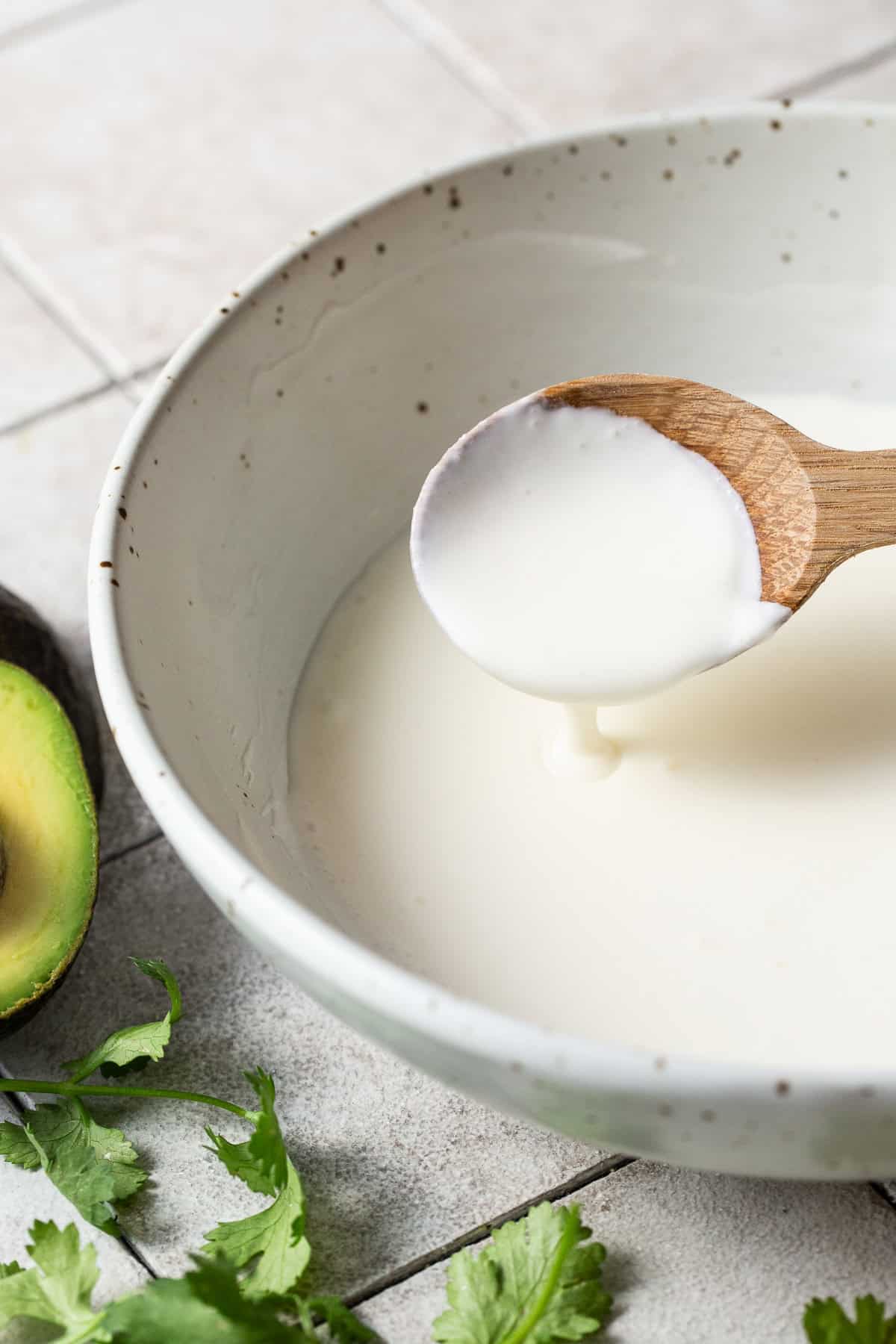 Mexican crema in a bowl with a spoon.