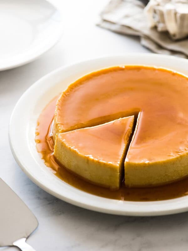 Flan on a plate with a slice cut out