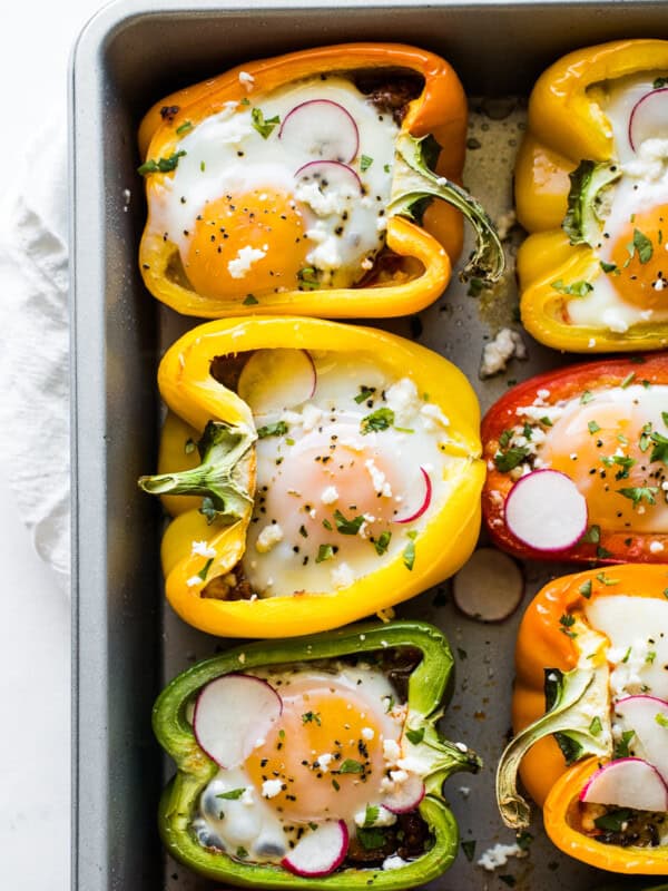 Breakfast stuffed peppers in a baking pan.