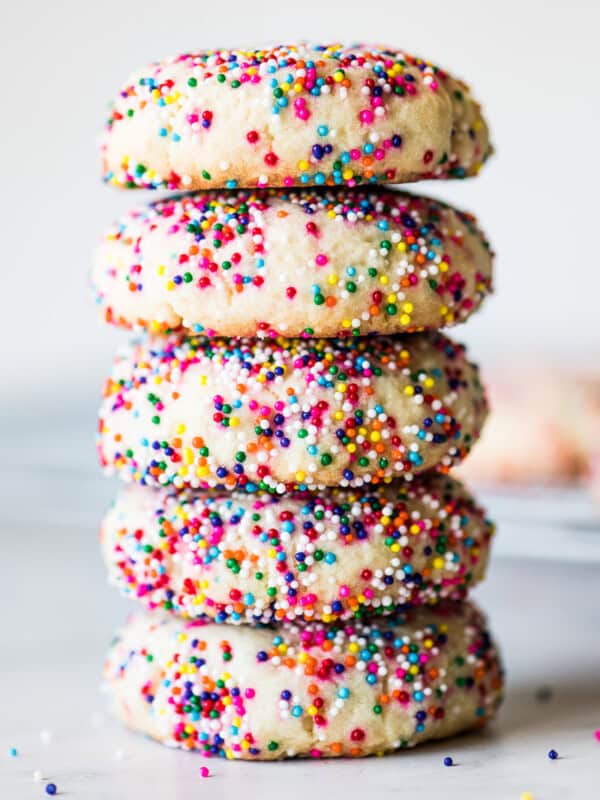 Sprinkle cookies stacked on top of one another.