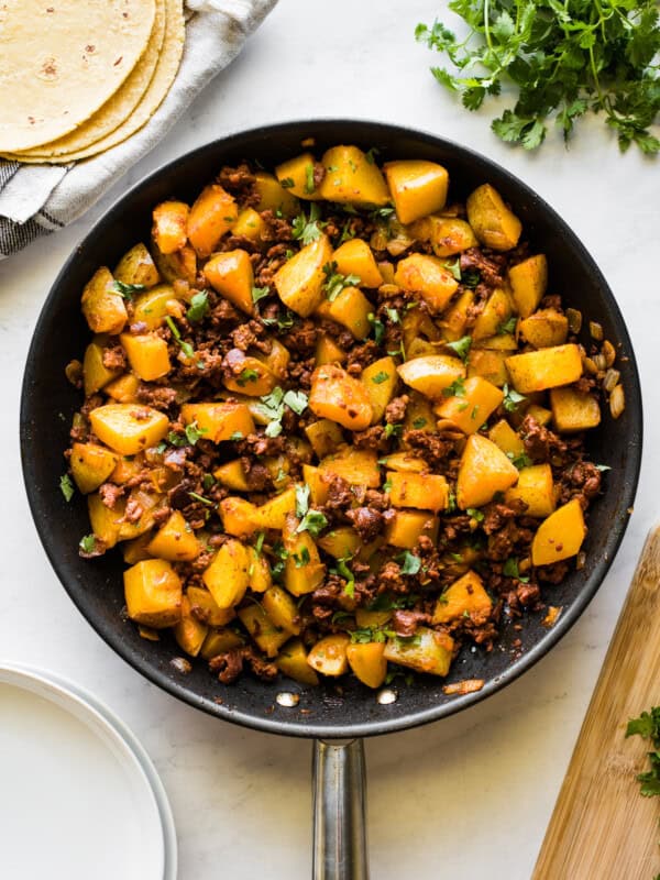 Papas con chorizo (or potatoes with chorizo) in a large skillet.