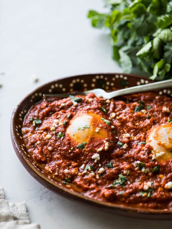 Huevos ahogados in a red salsa.