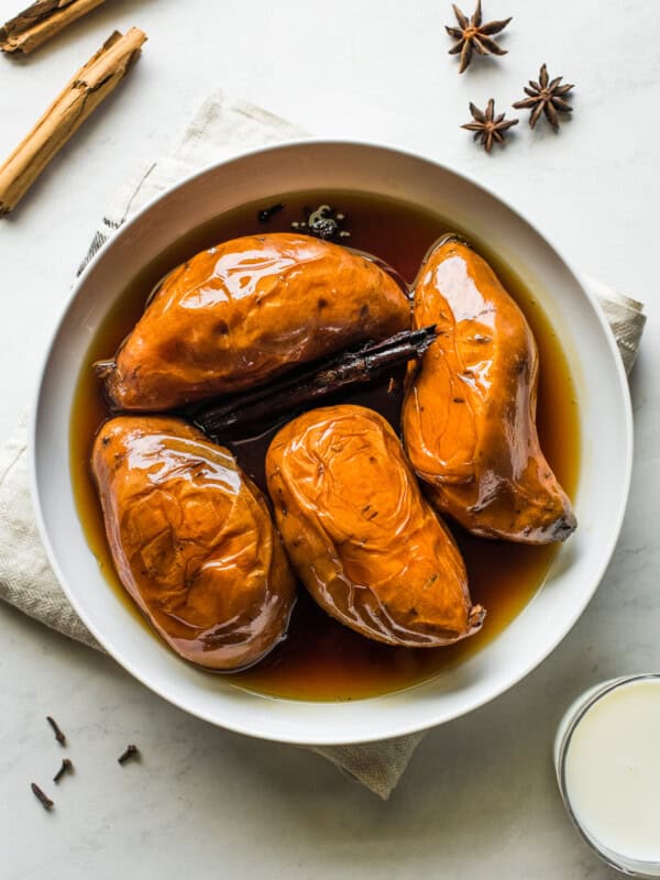 Camote enmielado in a large bowl with piloncillo syrup.