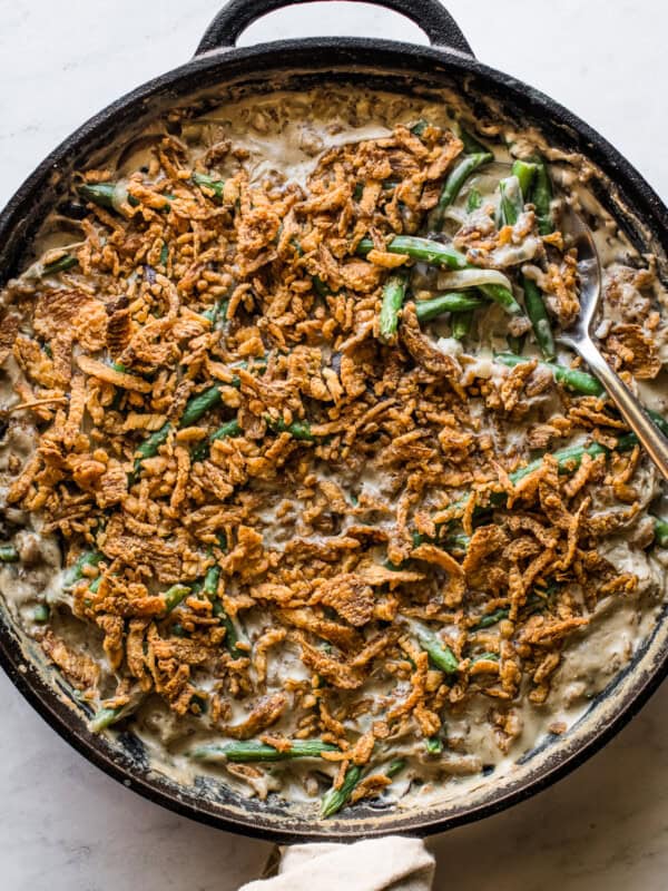 Green bean casserole recipe in a large skillet ready to serve.