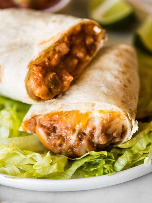 A bean and cheese burrito with melted cheese and refried beans.