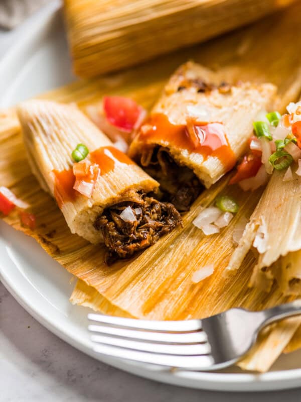 An Instant Pot Pork Tamale cut in half to show the center.