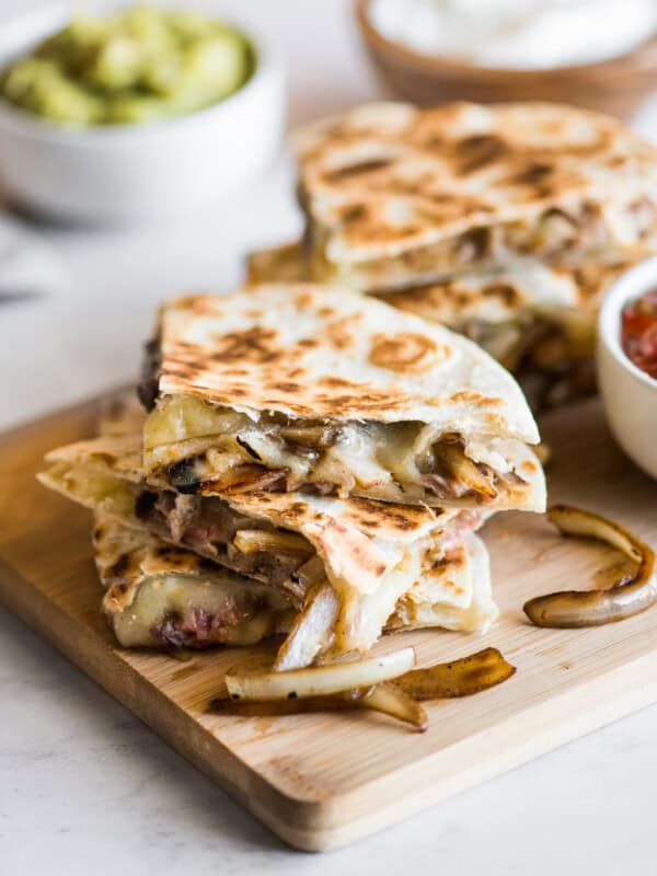 Steak quesadillas with melted cheese and sauteed onions.