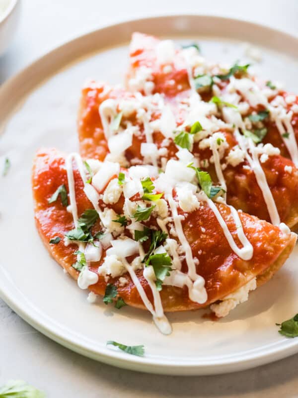 Entomatadas topped with queso fresco and Mexican crema.